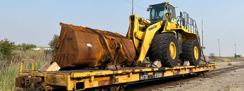 Open top railcars loaded with hi wide dimenstional contruction equipment