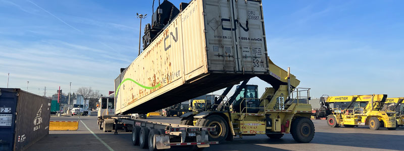 Imblanaced container being removed from chassis for reworking